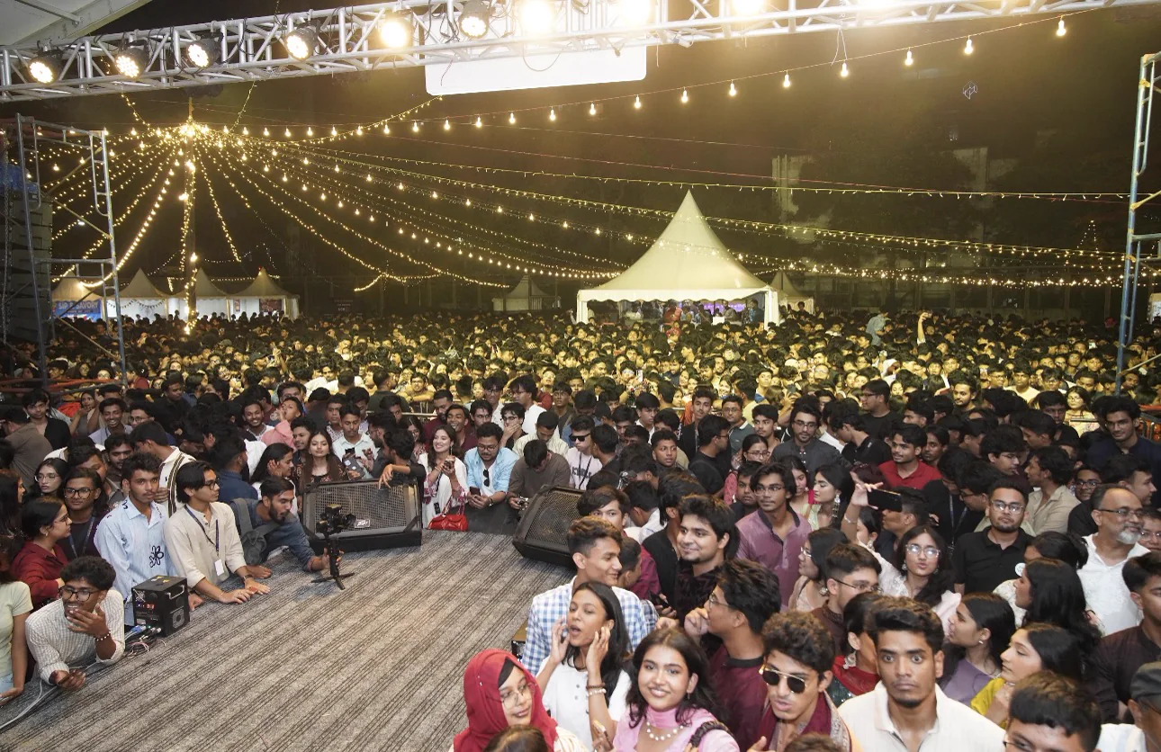 A full Eid-E-Bahar nighttime crowd beneath strings of warm lights